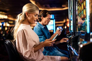 A cheerful woman in traditional clothing using her smartphone during a festive moment, showing how easily the WIN7JILI app fits into everyday life.