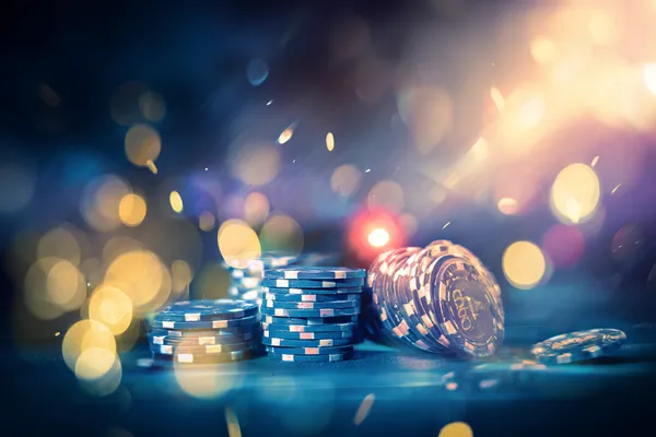 A glamorous woman holding casino chips in a neon-lit environment, representing the premium online casino atmosphere of WIN7JILI.