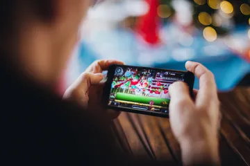 A professional dealer in a tuxedo greeting players at the roulette table, symbolizing the authentic live casino feel at WIN7JILI.